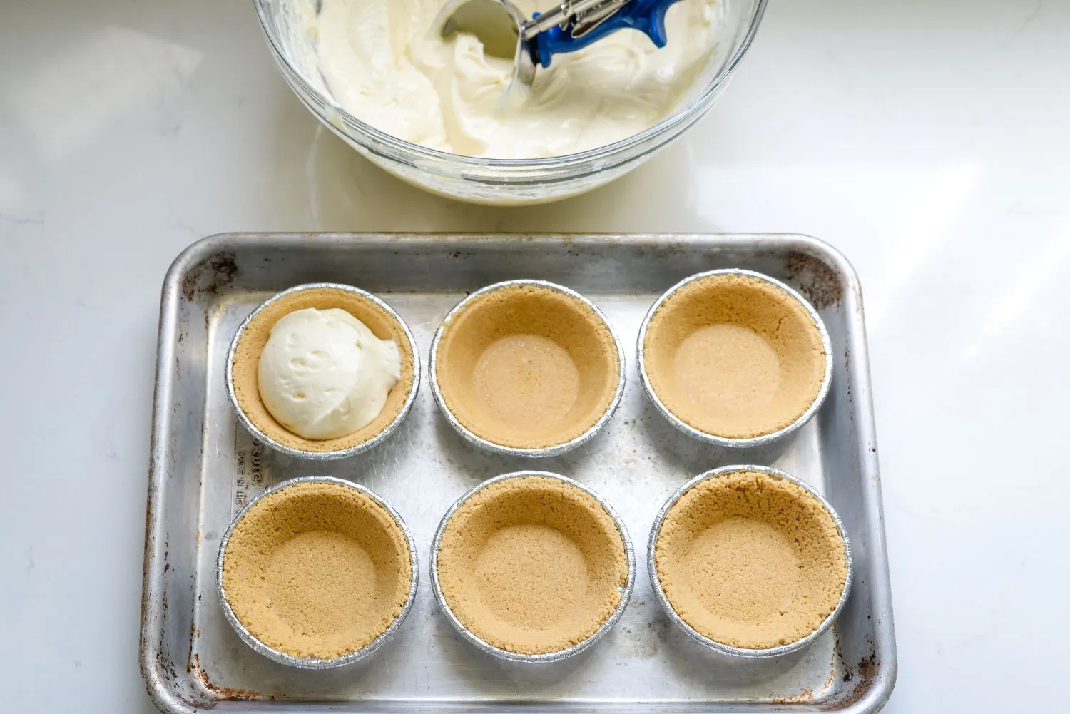 Mini-Key-Lime-Pies-4.jpg Key lime pie batter added into six mini graham cracker pie crusts to be refrigerated.