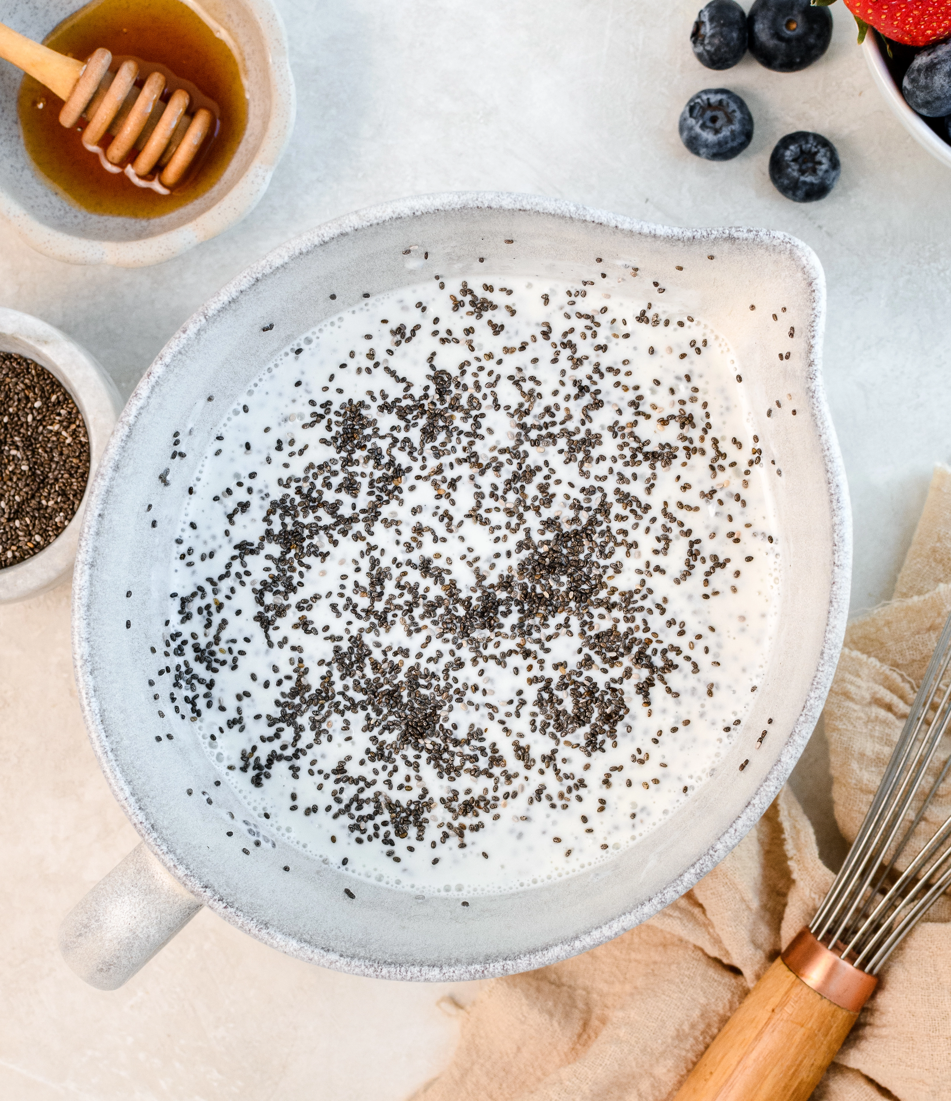 Greek yogurt and chia seeds in a bowl to make chia seed pudding.