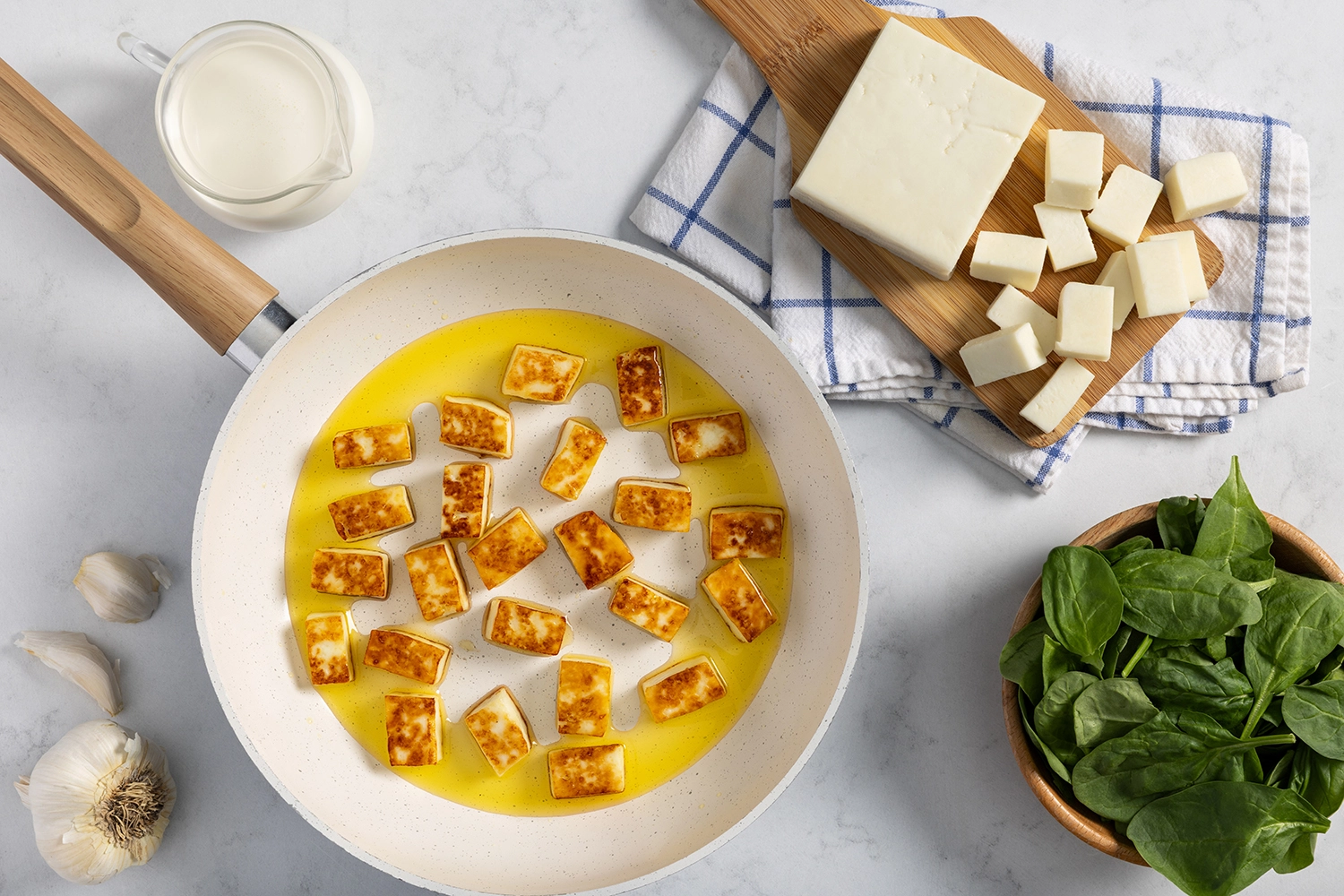 Paneer cooked in a large skillet with ghee until light golden-brown.