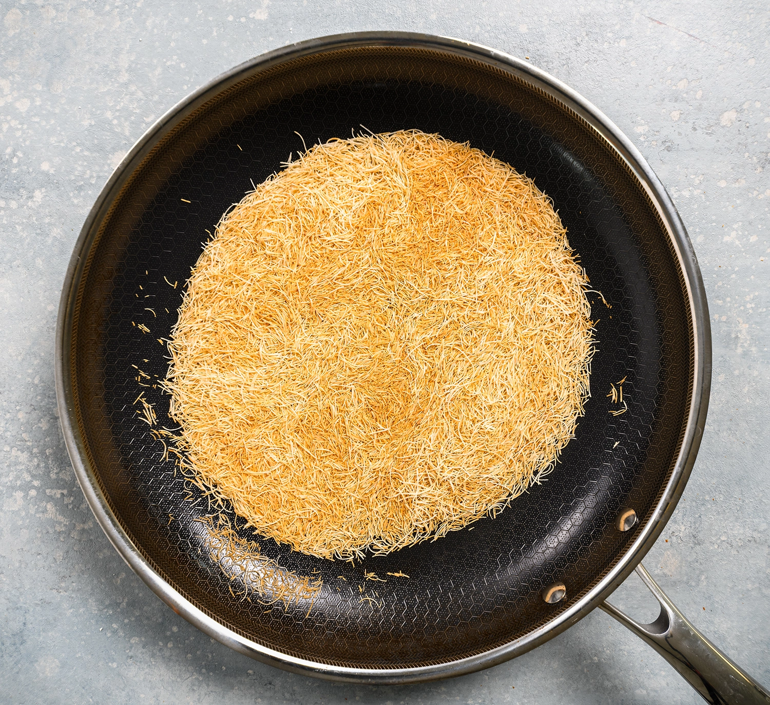 knafeh cut into small threats and toasted in a pan over medium heat.