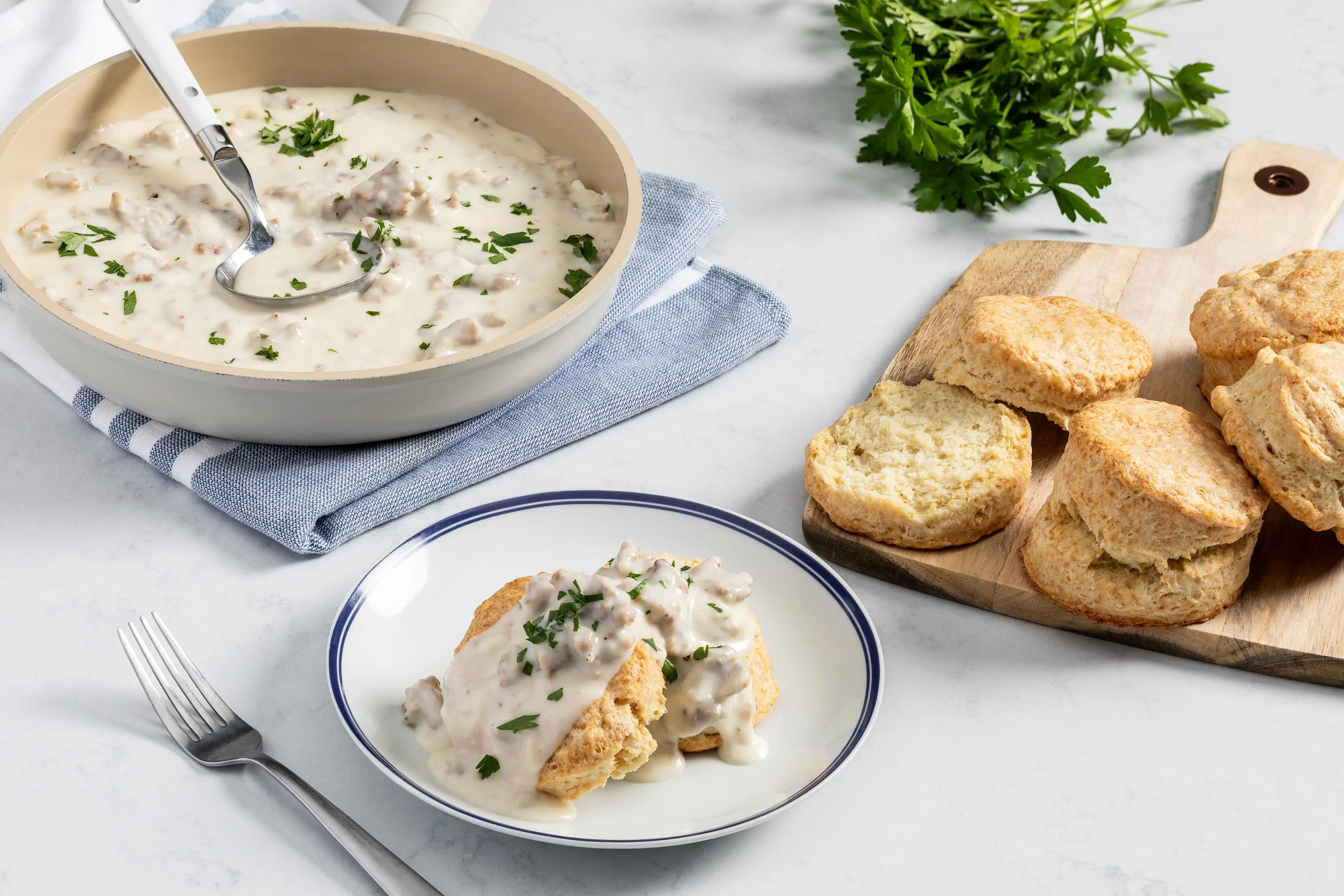 Easy sausage gravy and homemade biscuits served on a plate.