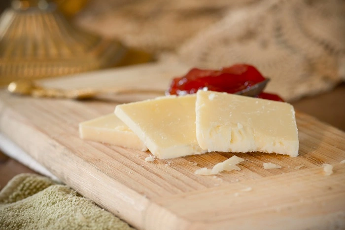 Three Slices of Aged Cheddar In A Platter