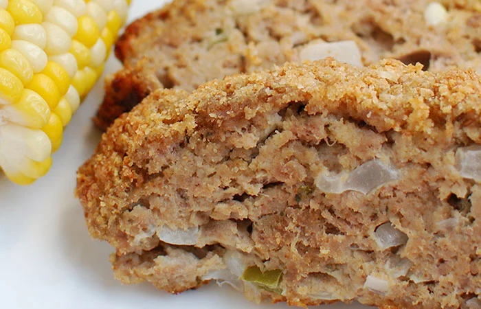 Corn on the cob and sliced meatloaf