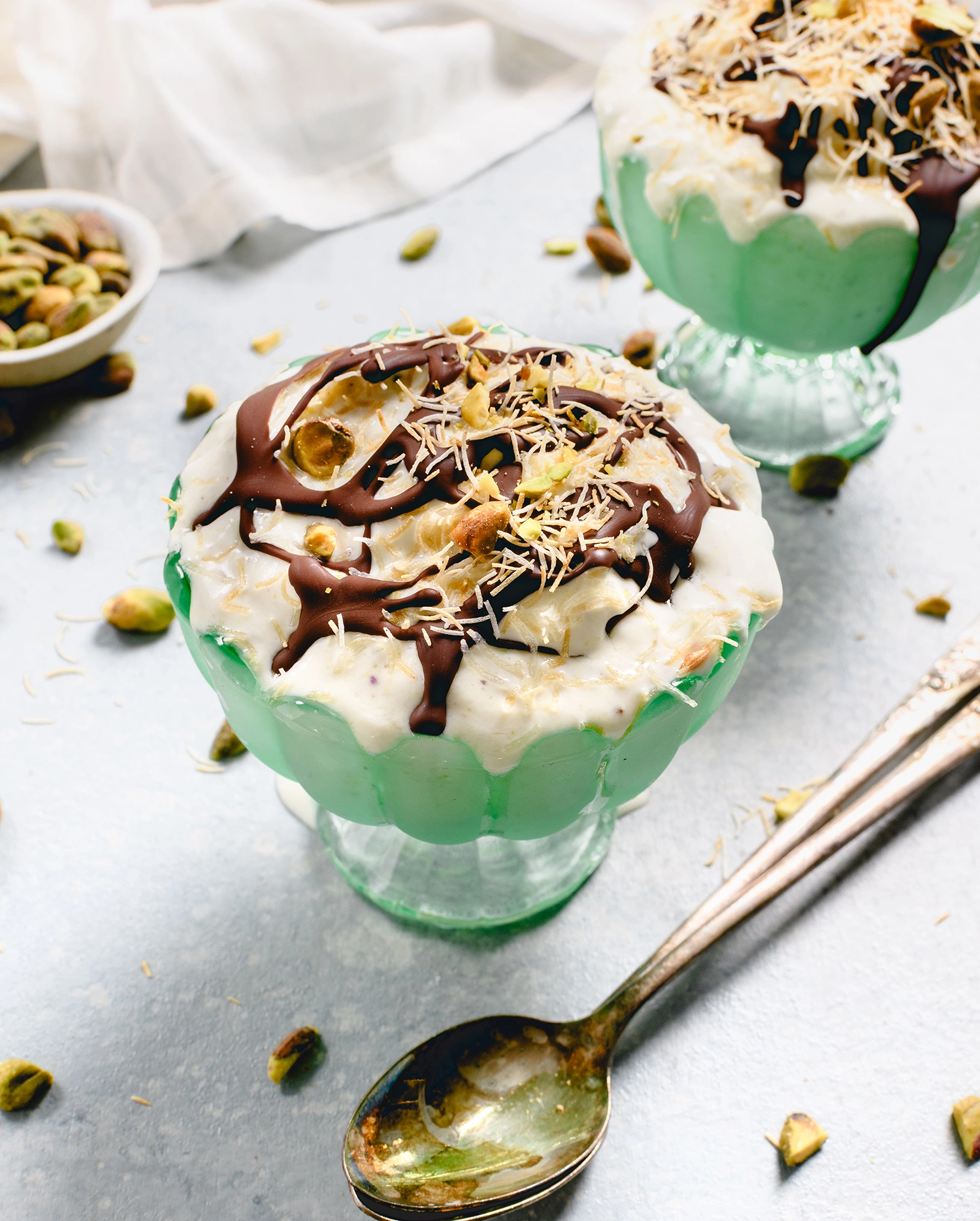 high-protein pistachio frozen yogurt with knafeh topped with pistachio cream and melted chocolate.