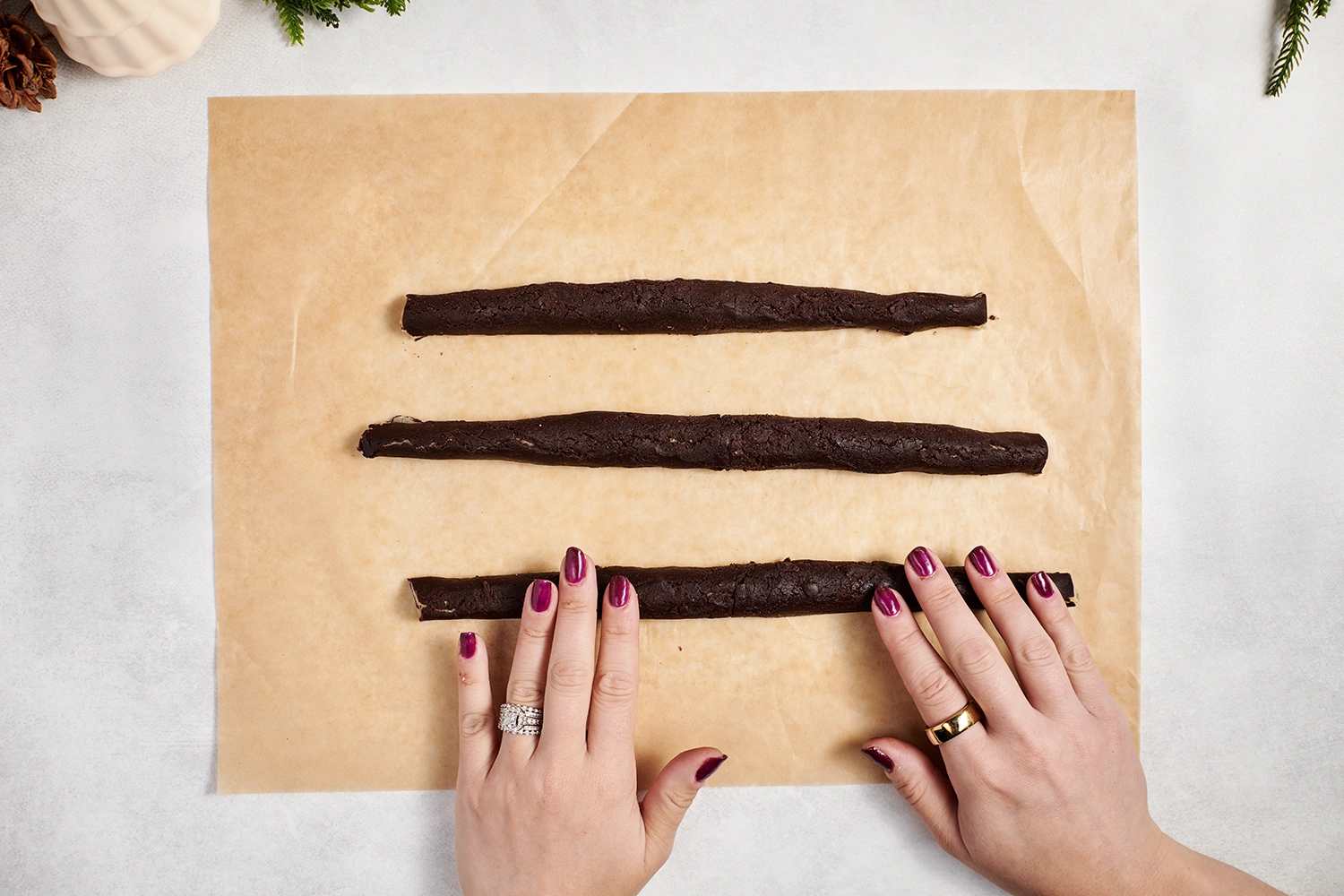 Chcolate- and vanilla-flavored dough is rolled lengthwise to make log shapes.