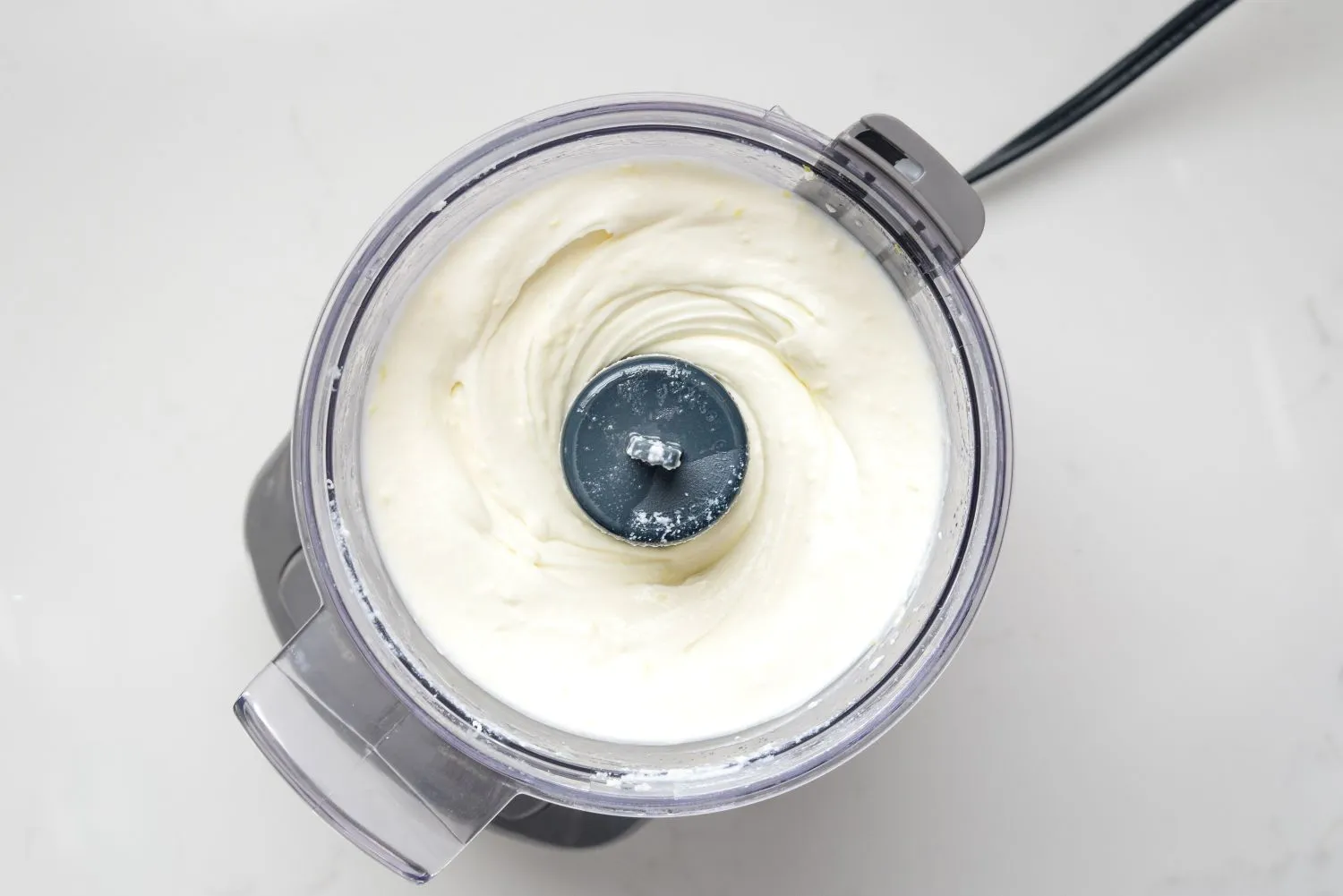 Ricotta cheese, lemon zest, and honey in a food processor.