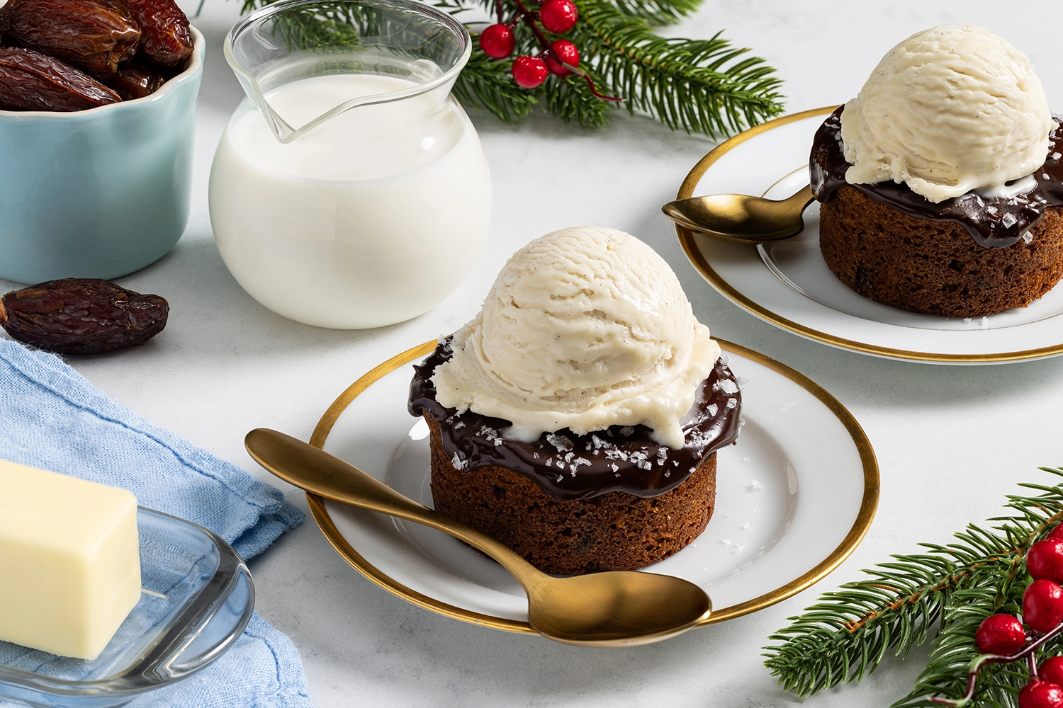 Dark chocolate date cakes topped with vanilla ice cream and flakey salt, ready to be served.