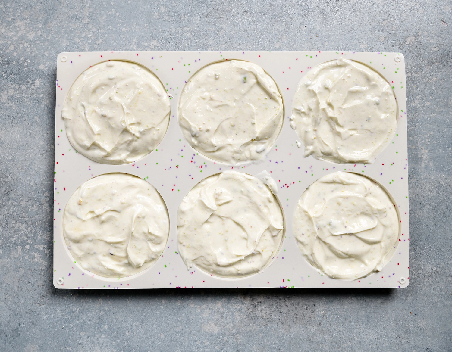 whole milk Greek yogurt, honey, and chopped pistachios mixture in silicone molds.