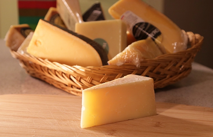 Piece of Aged Parmesan And Other Aged Cheeses In A Gift Basket