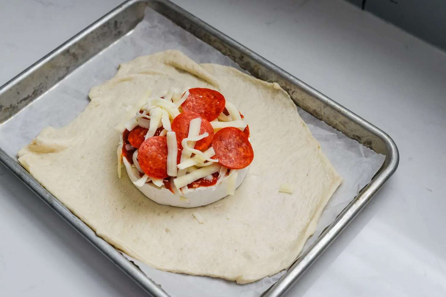 Brie wheel pizza on top of pizza crust